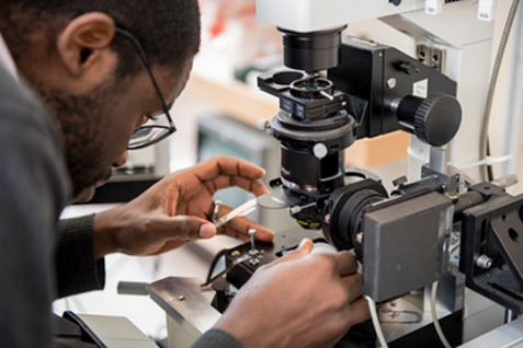 Resident looking through micrscope